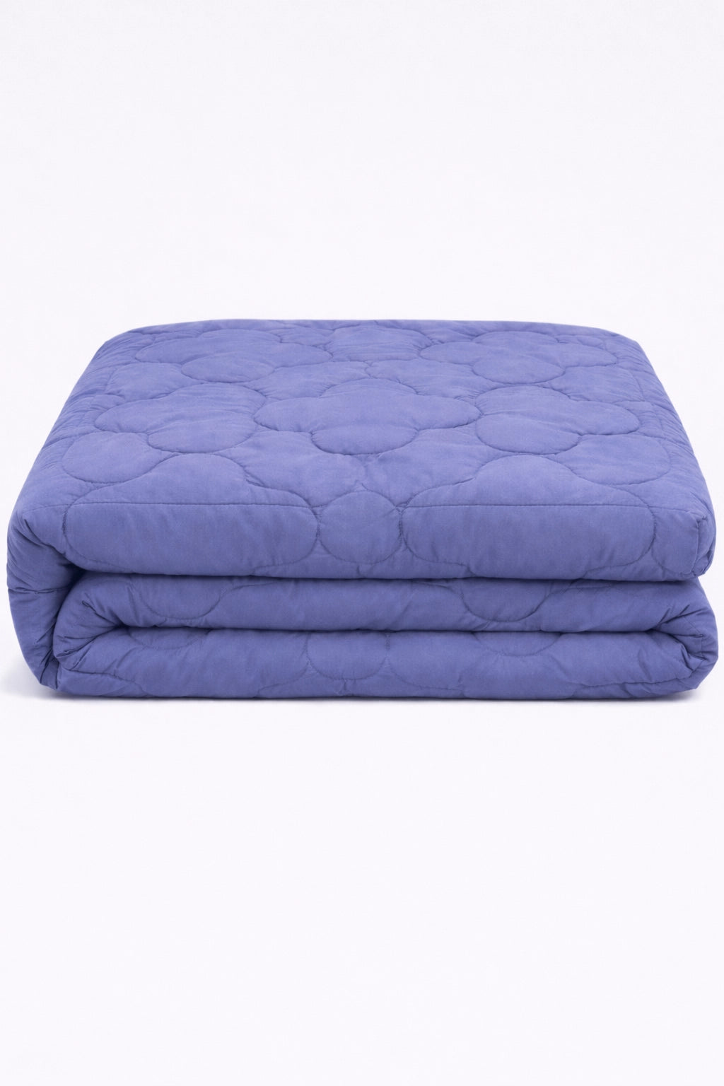 folded lilac comforter with clover quilted pattern stacked to highlight soft padded texture