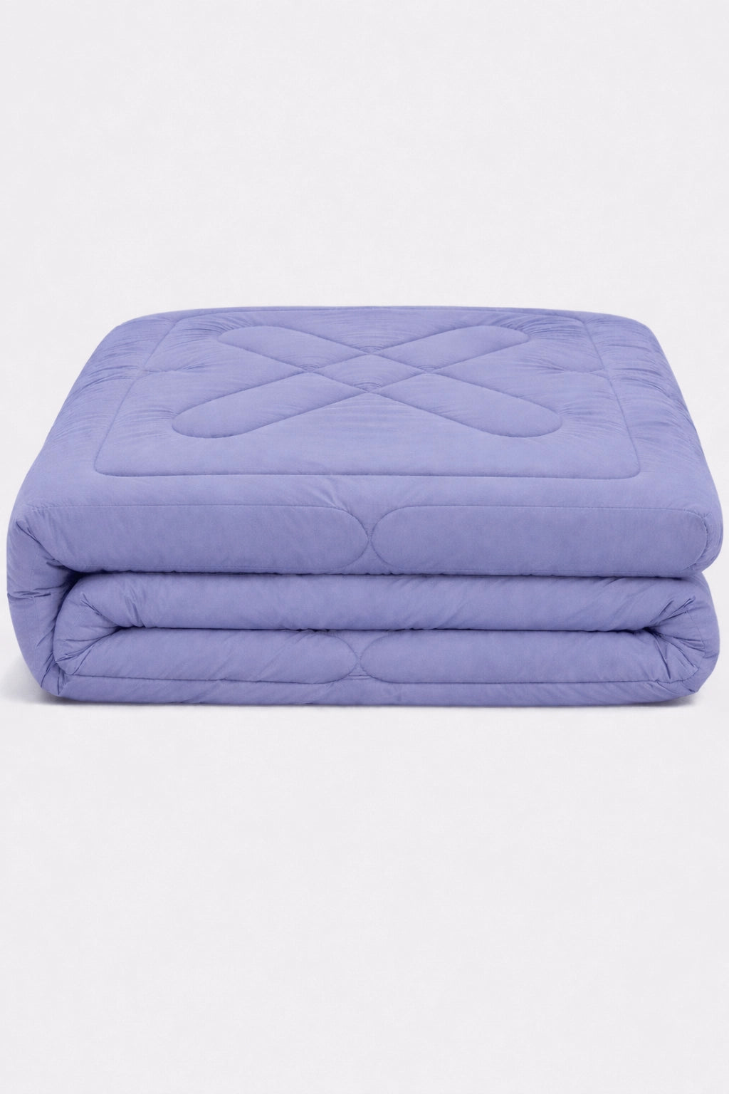 folded lilac comforter with diamond quilted pattern stacked to highlight soft padded texture