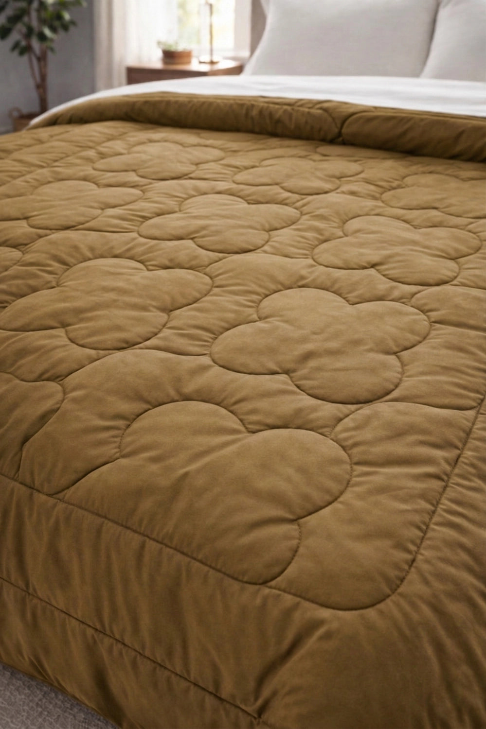 Close-up of clover quilt stitching on Mustard and Crème comforter fabric