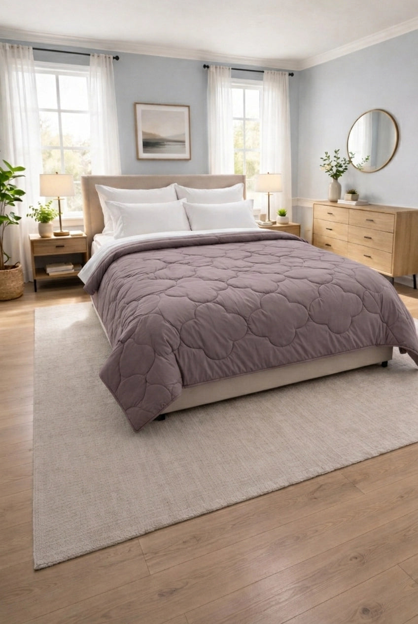 Compact stack of folded reversible comforter in Petal and Parchment shades