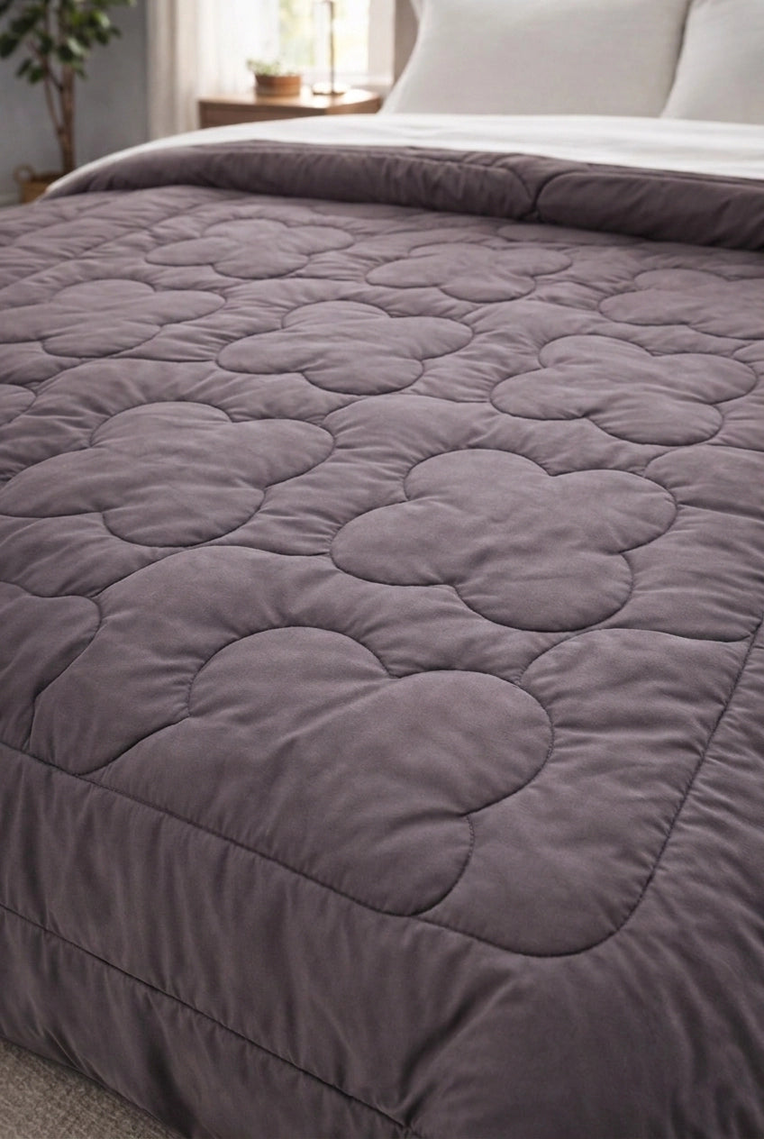 Detailed view of clover quilt stitching on Petal and Parchment comforter fabric