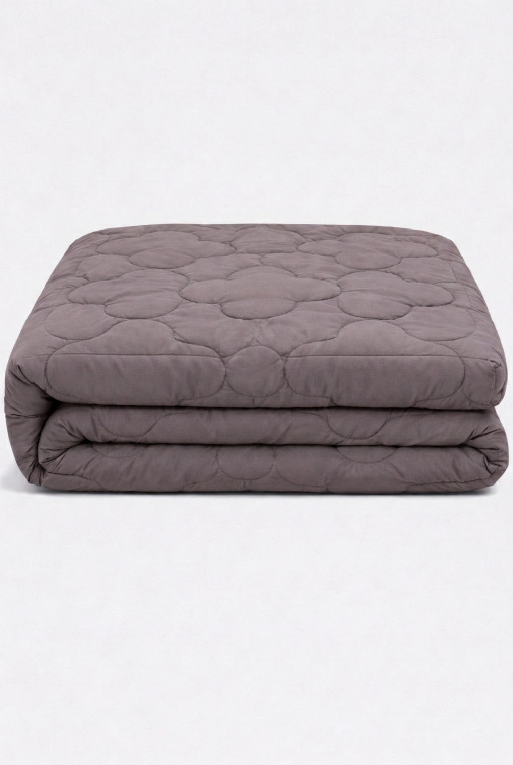 folded comforter with clover quilted pattern stacked to highlight soft padded texture