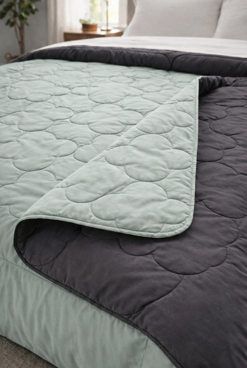 Folded corner view of reversible comforter showing soft microfiber layers and stitched quilting