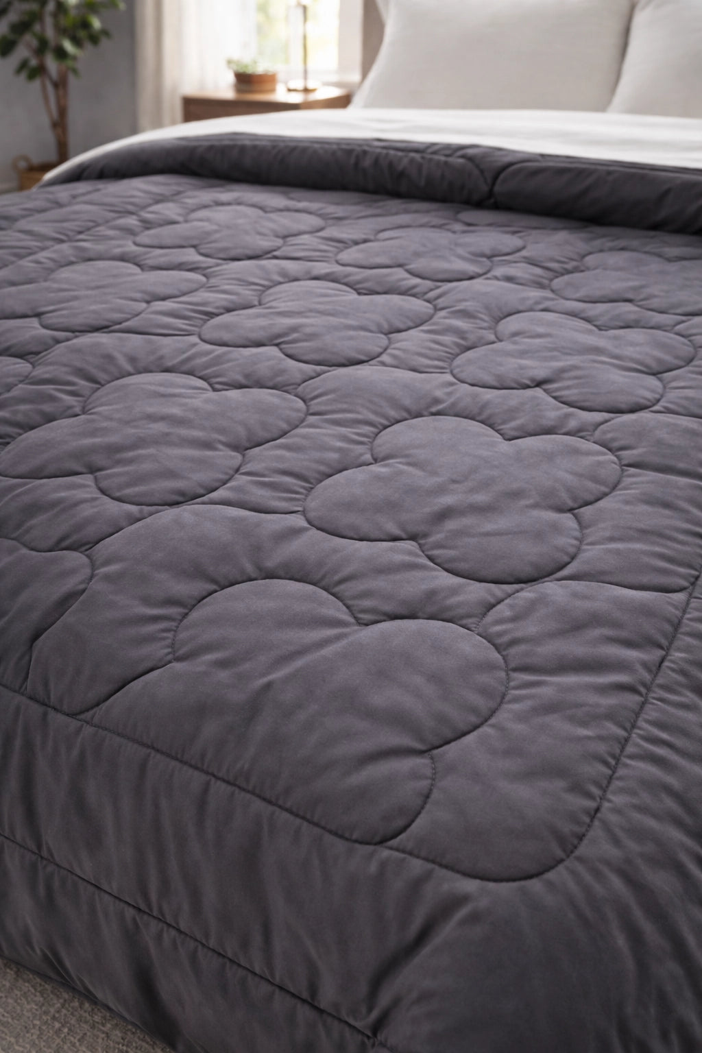 Close-up of clover quilt pattern stitched into Shadow and Steel comforter fabric