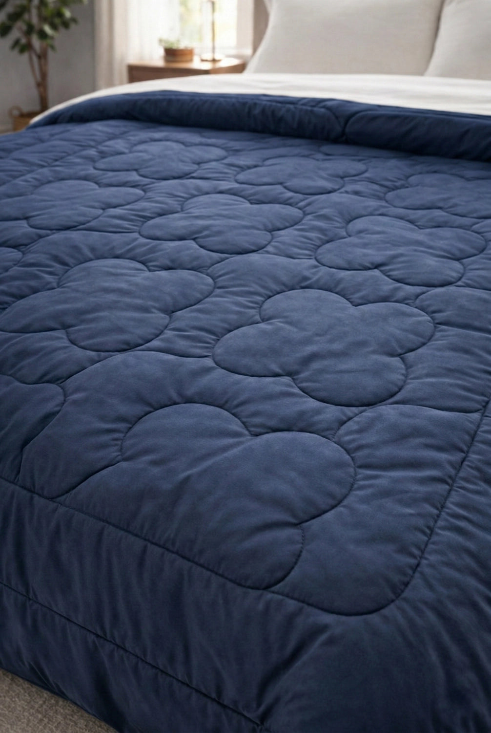 Neatly folded microfiber reversible comforter in Twilight and Rose color combination