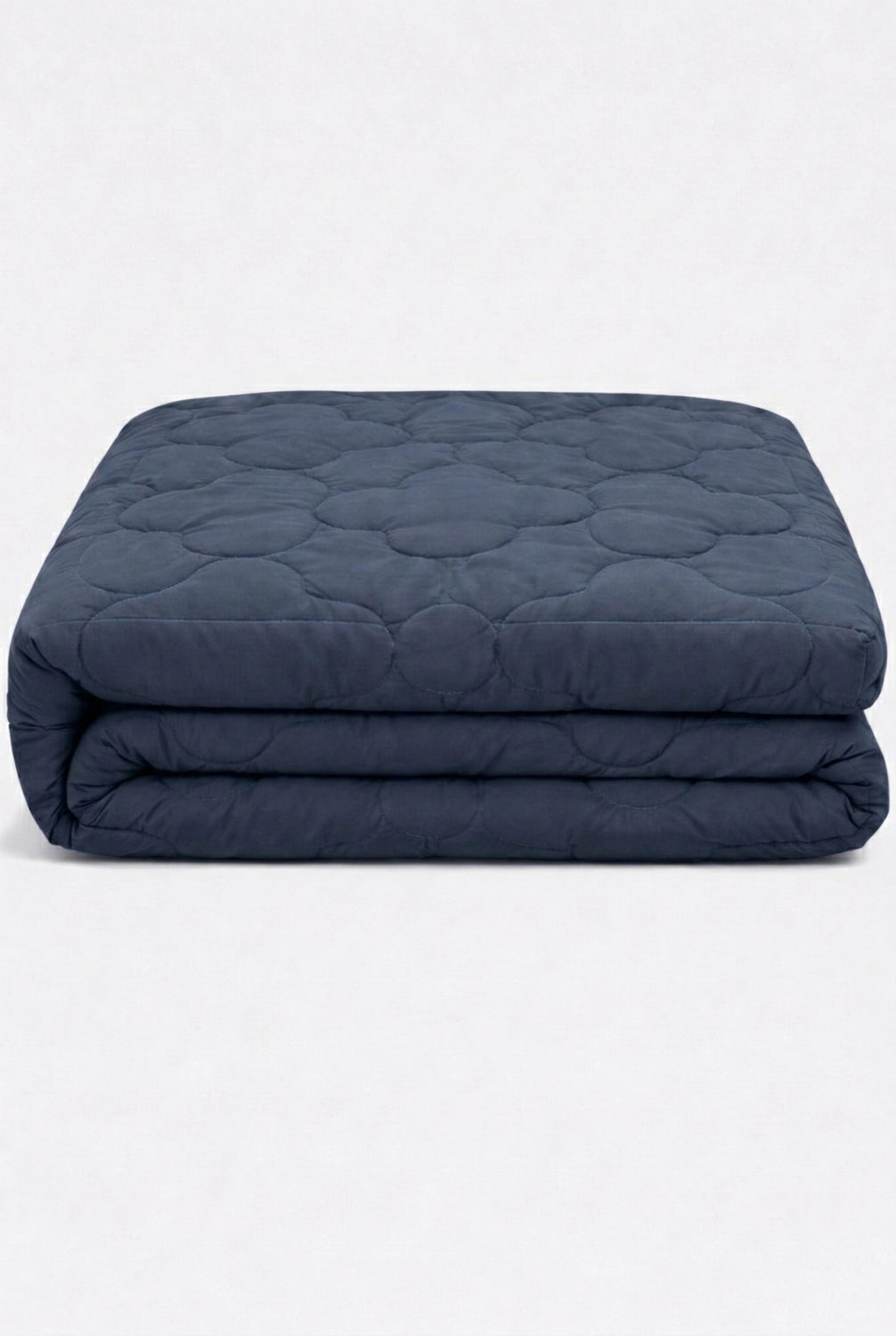 folded navy blue bedsheet set with soft quilted finish displayed on a clean white background