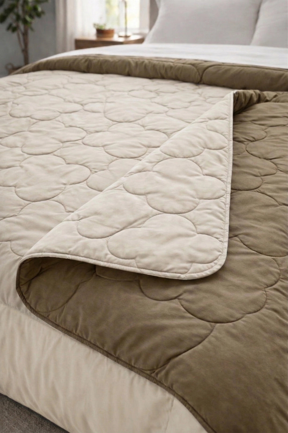 Folded section of microfiber comforter highlighting padded quilting and layered stitching