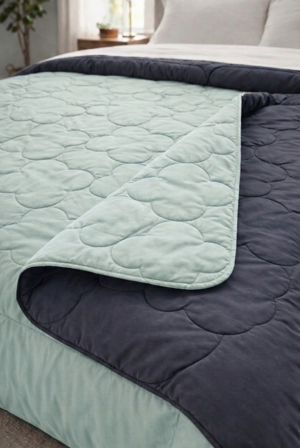 Close view of quilted microfiber comforter texture placed over bedsheets cotton